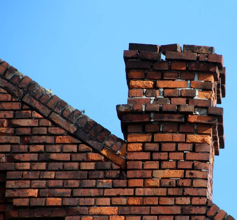 Damaged chimney on an Dearborn Heights home showing cracks and missing mortar